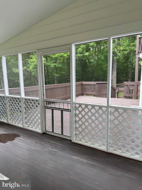  - unfurnished sunroom featuring vaulted ceiling and plenty of natural light