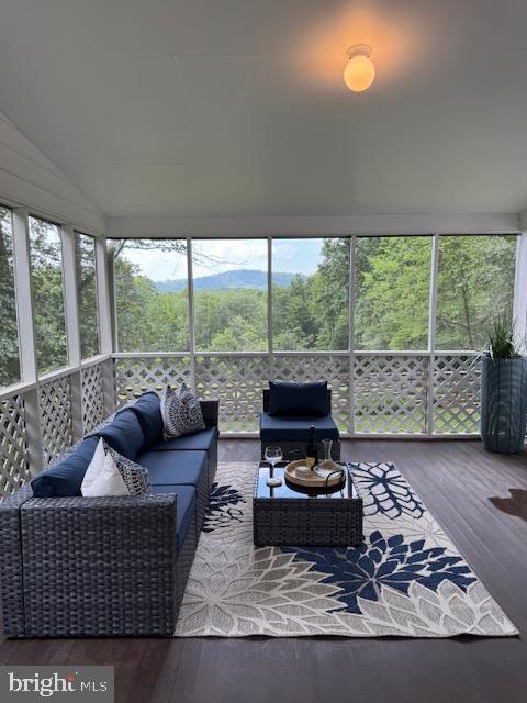  - sunroom / solarium featuring an outdoor hangout area and vaulted ceiling