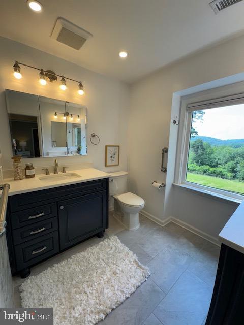  - bathroom featuring vanity, toilet, recessed lighting, and baseboards