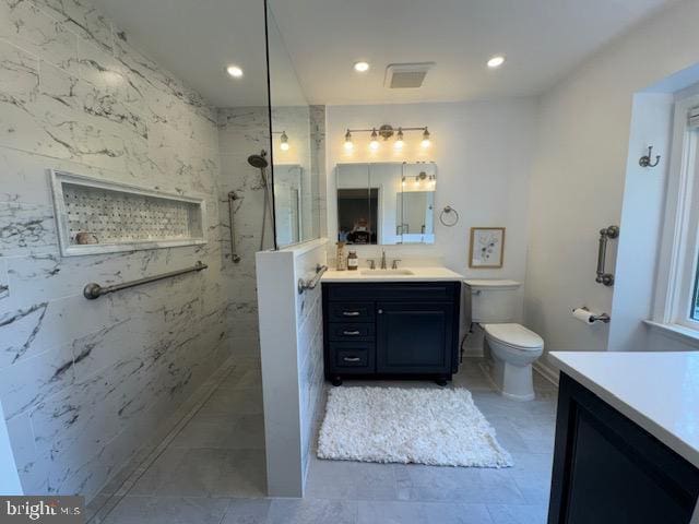  - full bath with vanity, a marble finish shower, toilet, and recessed lighting