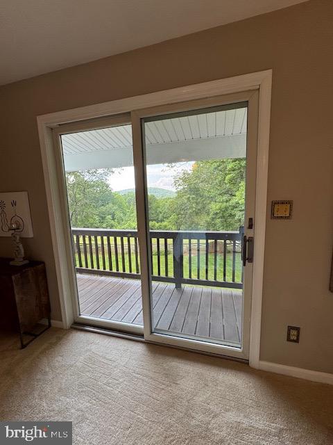  - entryway with carpet flooring and baseboards