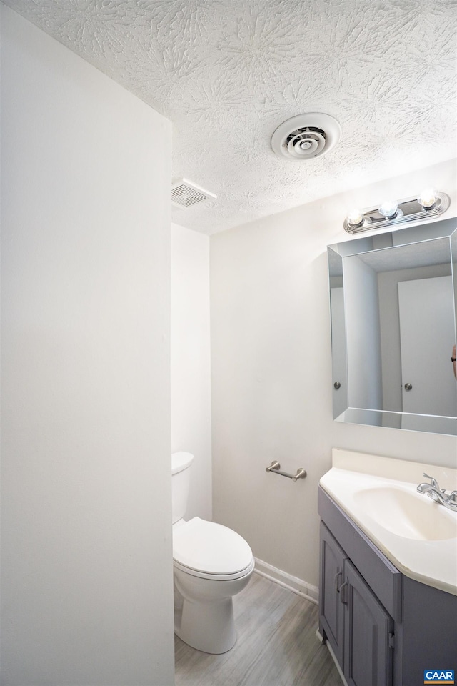 158 Scarborough Pl, Charlottesville, VA 22903 - bathroom with wood finished floors, vanity, and a textured ceiling
