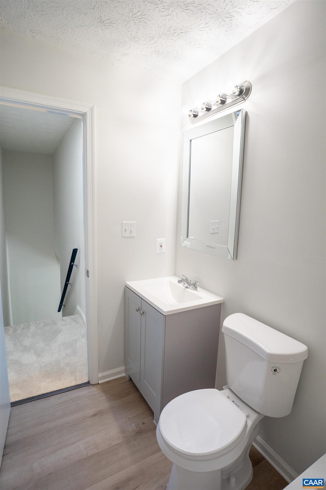 158 Scarborough Pl, Charlottesville, VA 22903 - half bathroom with wood finished floors, vanity, and a textured ceiling
