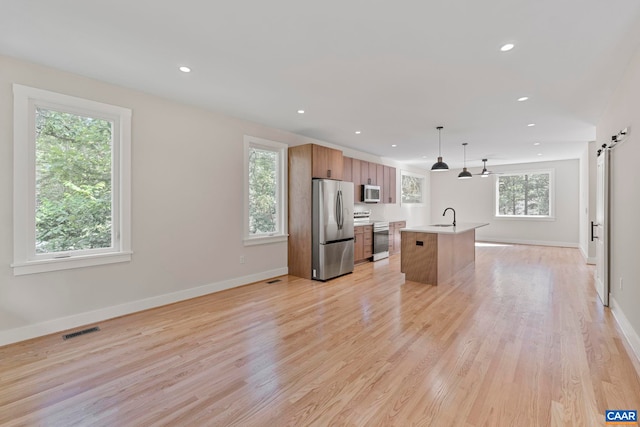 34 Turkeysag Trl, Palmyra, VA 22963 - kitchen with appliances with stainless steel finishes, recessed lighting, light countertops, an island with sink, and brown cabinets