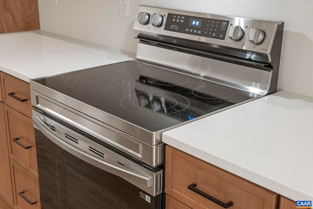 34 Turkeysag Trl, Palmyra, VA 22963 - kitchen featuring electric range, brown cabinetry, and light countertops