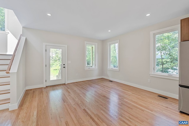 34 Turkeysag Trl, Palmyra, VA 22963 - unfurnished living room featuring plenty of natural light, light wood finished floors, stairs, and recessed lighting
