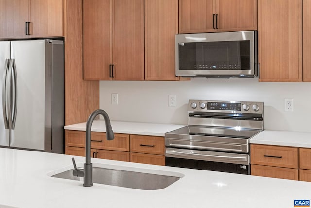 34 Turkeysag Trl, Palmyra, VA 22963 - kitchen with stainless steel appliances, light countertops, and brown cabinets