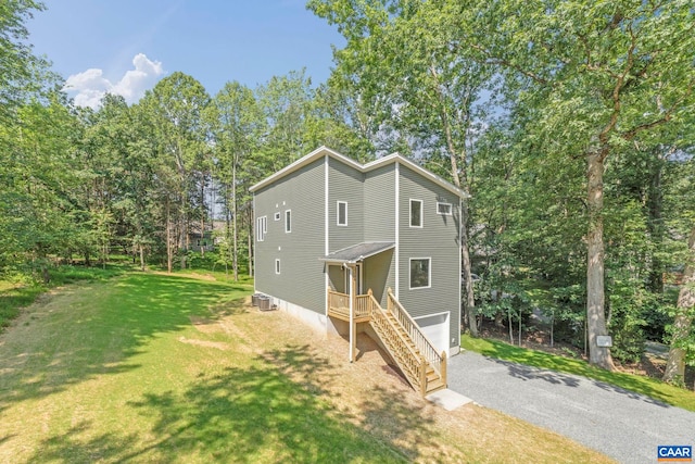 34 Turkeysag Trl, Palmyra, VA 22963 - view of front of property featuring a garage, a front yard, driveway, and view of wooded area
