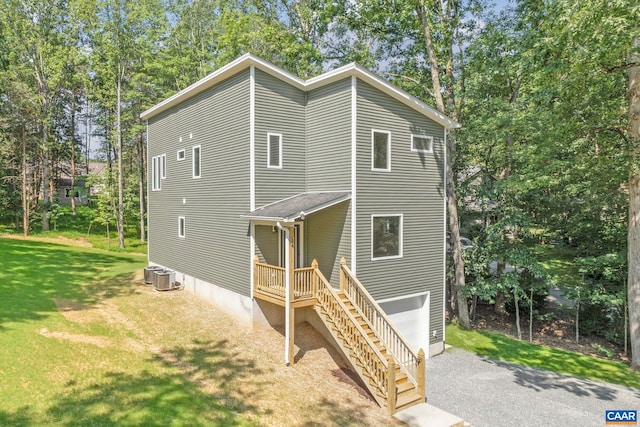 34 Turkeysag Trl, Palmyra, VA 22963 - view of front of home with a front lawn, view of wooded area, and an attached garage