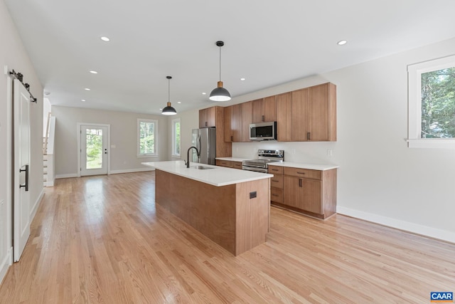 34 Turkeysag Trl, Palmyra, VA 22963 - kitchen featuring appliances with stainless steel finishes, brown cabinets, light wood-style floors, light countertops, and recessed lighting