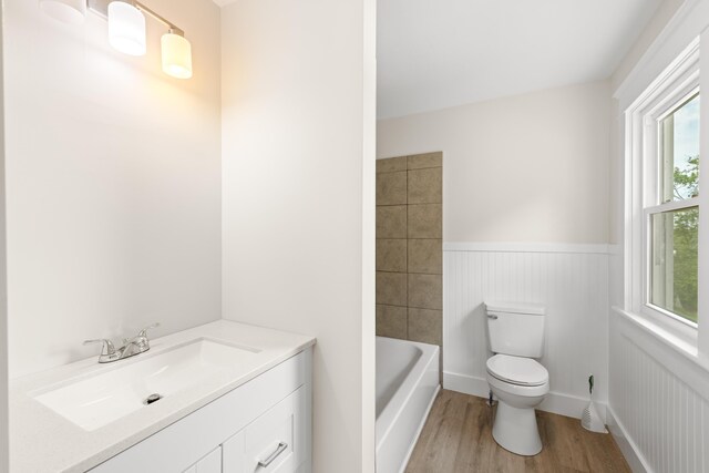 630 Battlefield Rd, Fort Defiance, VA 24437 - full bathroom with wainscoting, toilet, wood finished floors, a tub, and a shower