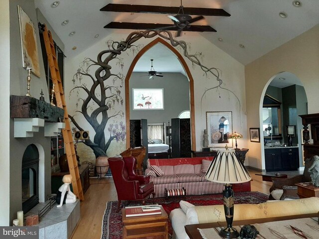5902 Patriot Hwy, Woodford, VA 22580 - living room featuring ceiling fan, high vaulted ceiling, light wood-type flooring, beamed ceiling, and arched walkways