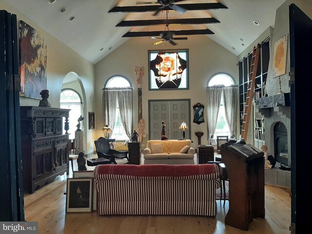 5902 Patriot Hwy, Woodford, VA 22580 - living room with a glass covered fireplace, wood finished floors, high vaulted ceiling, ceiling fan, and beam ceiling
