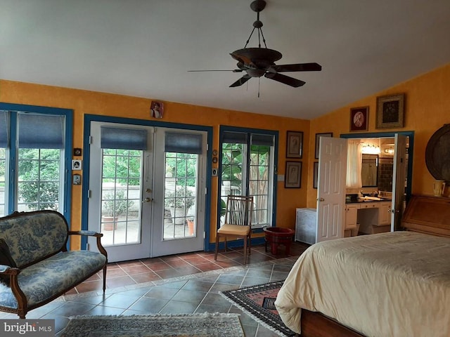 5902 Patriot Hwy, Woodford, VA 22580 - bedroom with french doors, multiple windows, access to outside, vaulted ceiling, and dark tile patterned flooring