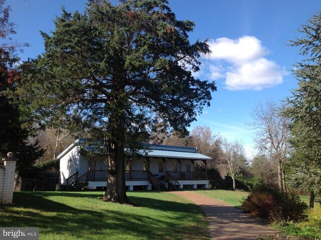 5902 Patriot Hwy, Woodford, VA 22580 - view of front of home with a porch, a front yard, and metal roof