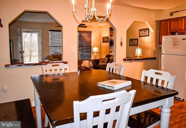 4551 Grove Hill River Rd, Shenandoah, VA 22849 - dining space featuring arched walkways, a chandelier, and dark wood-style floors