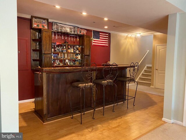 6029 Lost Cove Dr, Mineral, VA 23117 - indoor dry bar featuring ornamental molding, baseboards, stairs, light wood-style floors, and recessed lighting