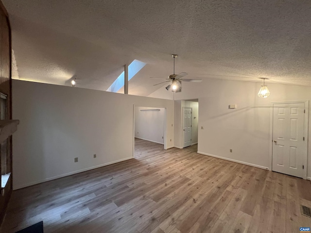 7 Englewood Dr, Palmyra, VA 22963 - unfurnished living room with a textured ceiling, lofted ceiling, ceiling fan, and wood finished floors
