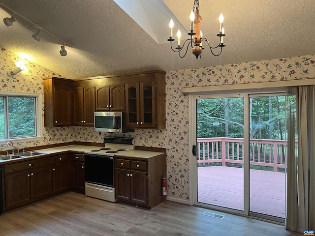 7 Englewood Dr, Palmyra, VA 22963 - kitchen with wallpapered walls, white electric stove, light wood finished floors, a textured ceiling, and plenty of natural light
