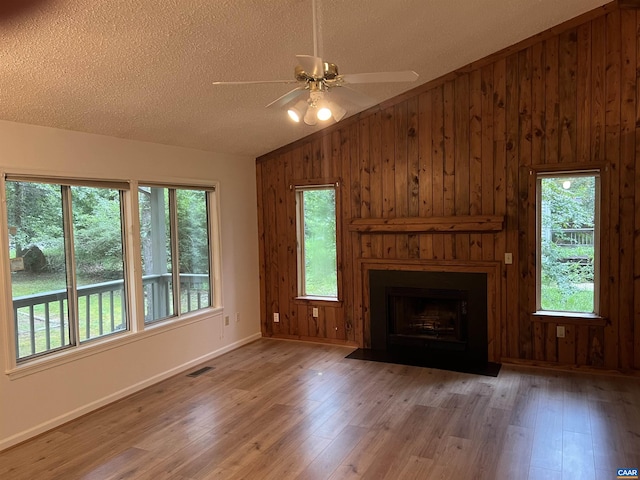7 Englewood Dr, Palmyra, VA 22963 - unfurnished living room featuring lofted ceiling, a ceiling fan, wood finished floors, a textured ceiling, and healthy amount of natural light