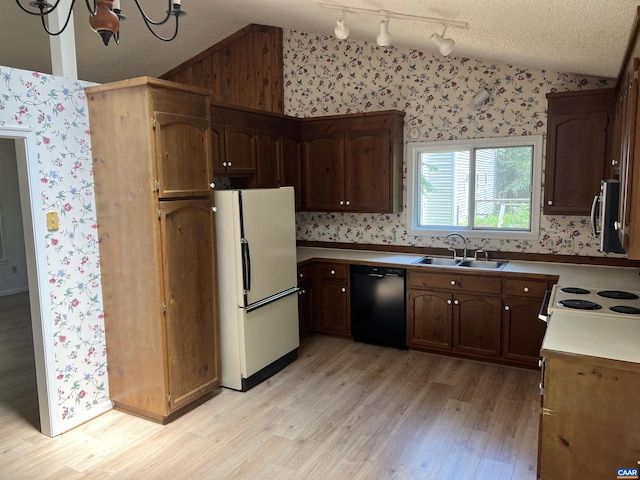 7 Englewood Dr, Palmyra, VA 22963 - kitchen featuring freestanding refrigerator, vaulted ceiling, wallpapered walls, black dishwasher, and light wood-type flooring