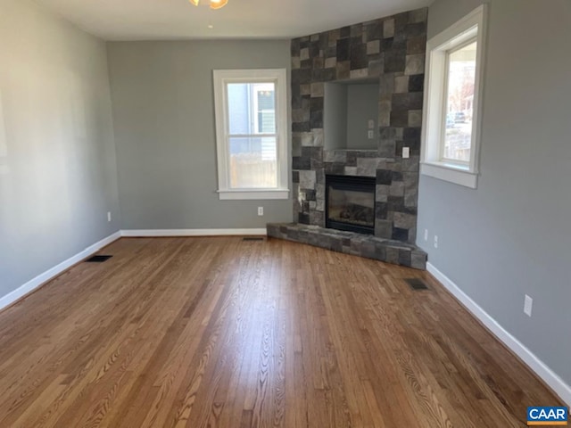1414 Midland St, Charlottesville, VA 22902 - unfurnished living room featuring wood finished floors, baseboards, and a fireplace