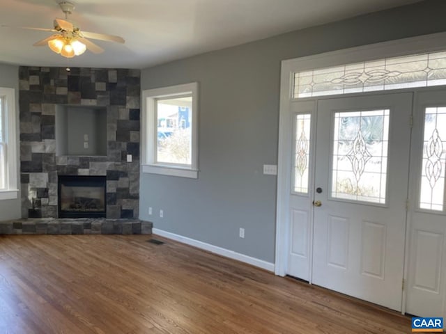 1414 Midland St, Charlottesville, VA 22902 - foyer featuring wood finished floors, baseboards, a tiled fireplace, and ceiling fan