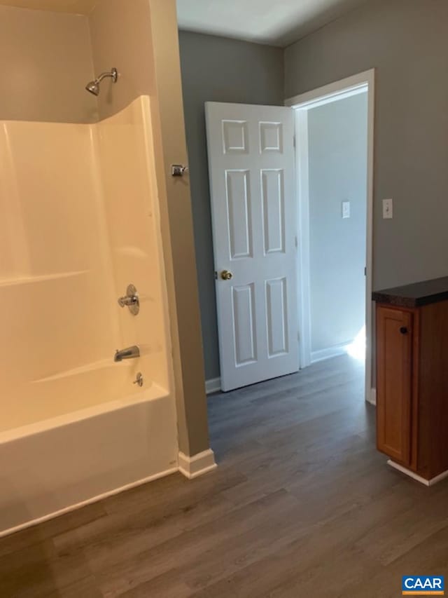 1414 Midland St, Charlottesville, VA 22902 - bathroom with wood finished floors,  shower combination, baseboards, and vanity