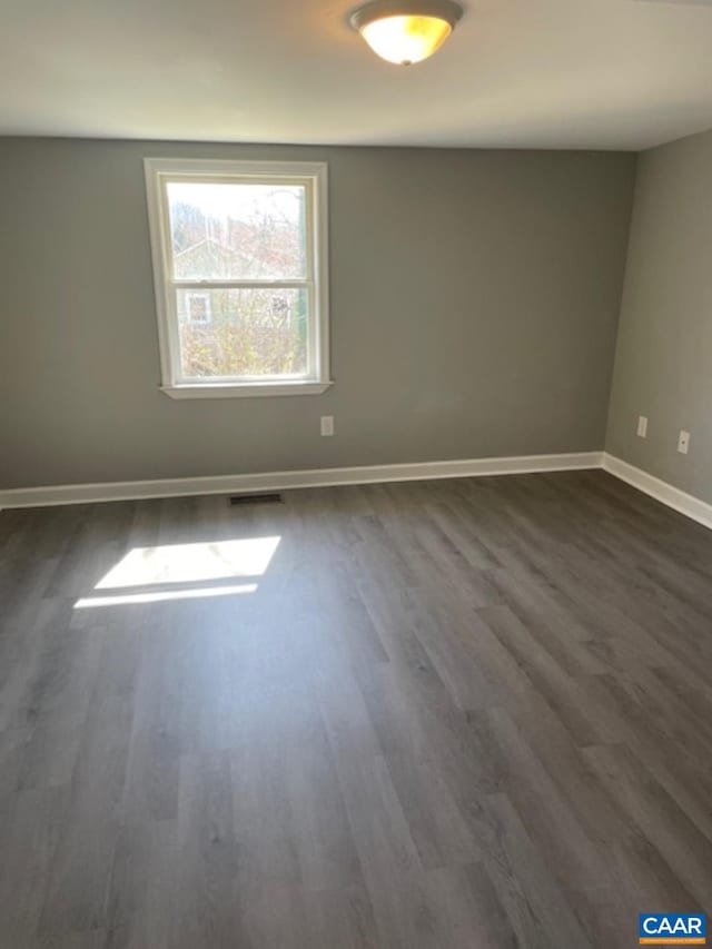1414 Midland St, Charlottesville, VA 22902 - empty room featuring dark wood-style flooring and baseboards