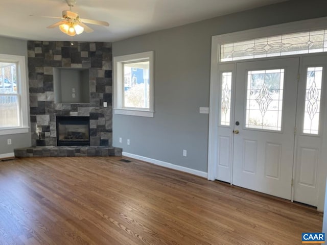 1414 Midland St, Charlottesville, VA 22902 - foyer with baseboards, wood finished floors, a tiled fireplace, and ceiling fan