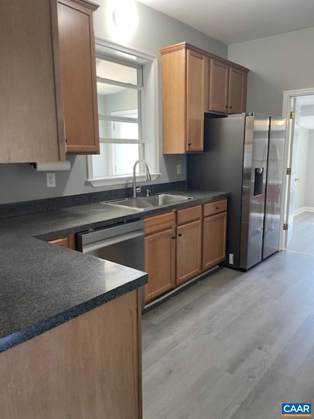 1414 Midland St, Charlottesville, VA 22902 - kitchen with a sink, dark countertops, stainless steel appliances, and light wood-style flooring