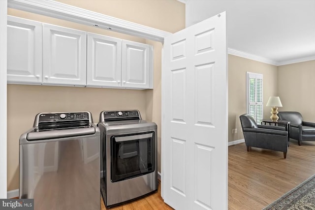 10042 Cedar Spring Ln, Culpeper, VA 22701 - laundry room featuring cabinet space, washer and dryer, ornamental molding, and light wood-type flooring
