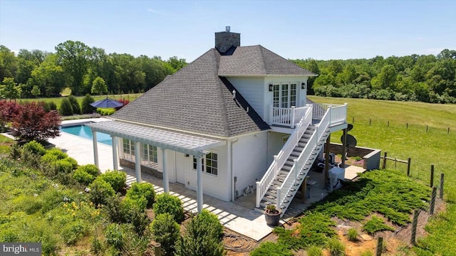 10042 Cedar Spring Ln, Culpeper, VA 22701 - rear view of property featuring roof with shingles, a patio, a chimney, and an outdoor pool