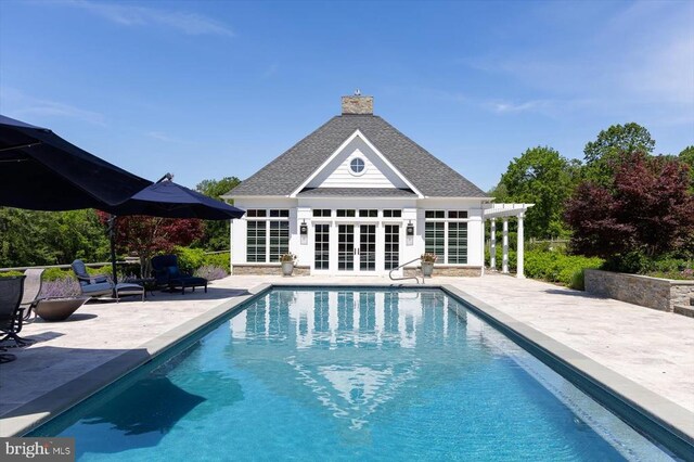 10042 Cedar Spring Ln, Culpeper, VA 22701 - outdoor pool with a storage structure, a patio, an outbuilding, and french doors