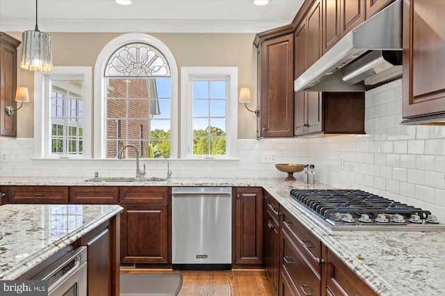 10042 Cedar Spring Ln, Culpeper, VA 22701 - kitchen with stainless steel appliances, under cabinet range hood, crown molding, light wood-style floors, and tasteful backsplash