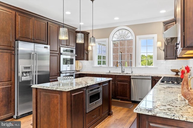 10042 Cedar Spring Ln, Culpeper, VA 22701 - kitchen featuring stainless steel appliances, ornamental molding, light wood-type flooring, decorative backsplash, and light stone countertops