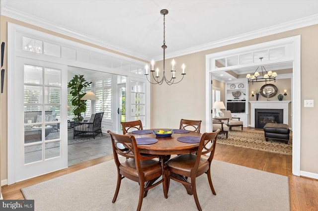 10042 Cedar Spring Ln, Culpeper, VA 22701 - dining room with crown molding, a chandelier, light wood finished floors, and a glass covered fireplace