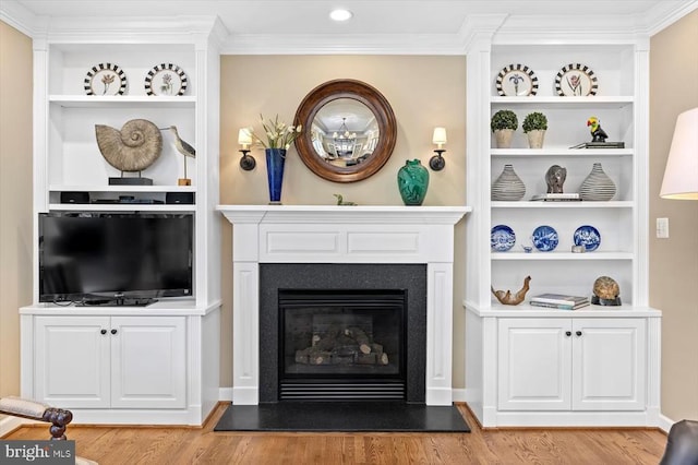 10042 Cedar Spring Ln, Culpeper, VA 22701 - living area with wood finished floors, crown molding, a glass covered fireplace, and built in shelves