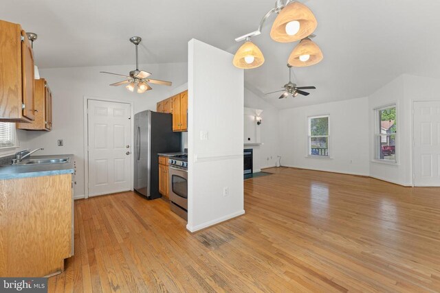 11505 Brian Dr, Fredericksburg, VA 22407 - kitchen with ceiling fan, stainless steel appliances, lofted ceiling, light wood finished floors, and a fireplace with flush hearth
