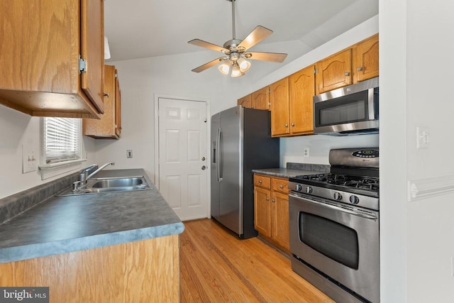 11505 Brian Dr, Fredericksburg, VA 22407 - kitchen featuring stainless steel appliances, light wood-type flooring, ceiling fan, brown cabinetry, and dark countertops