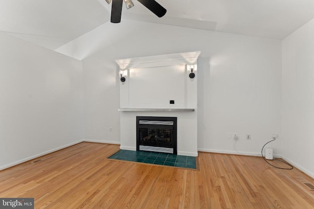 11505 Brian Dr, Fredericksburg, VA 22407 - unfurnished living room featuring lofted ceiling, ceiling fan, wood finished floors, and a tiled fireplace