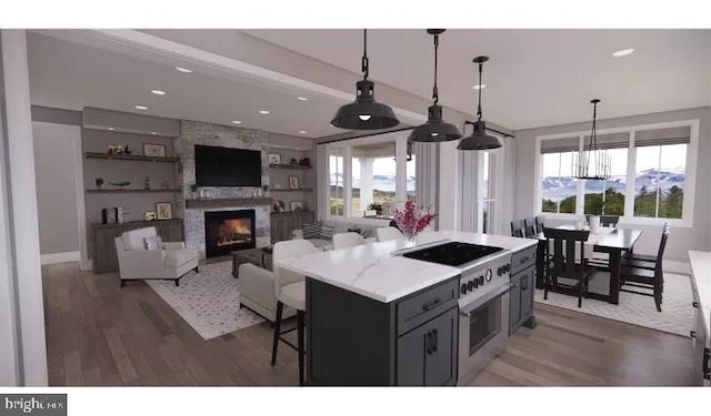 51 Lighthouse Dr, Bumpass, VA 23024 - kitchen featuring a large fireplace, wood finished floors, healthy amount of natural light, a chandelier, and recessed lighting