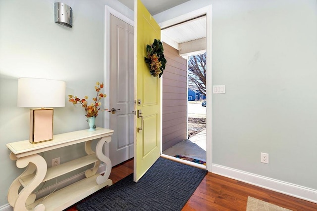 entrance foyer featuring a wealth of natural light, baseboards, and wood finished floors