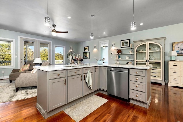 kitchen featuring open floor plan, dishwasher, gray cabinets, dark wood-style floors, and a sink