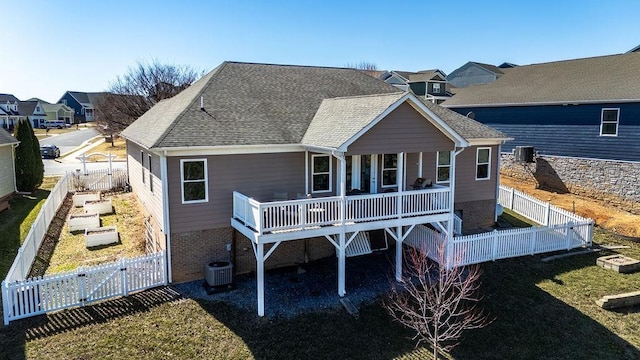 rear view of house featuring central AC, roof with shingles, a deck, a fenced backyard, and a gate