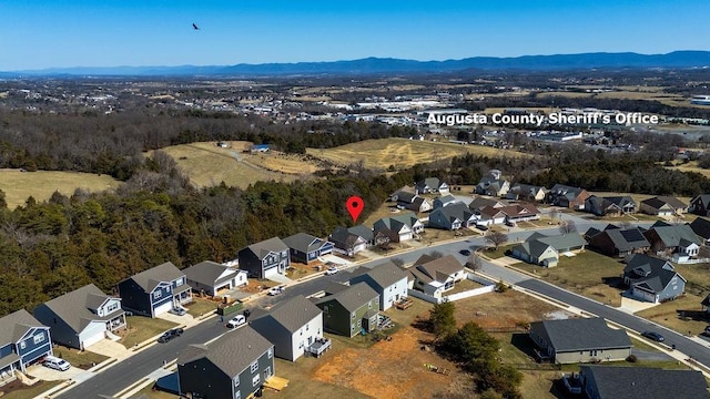 birds eye view of property with a mountain view and a residential view