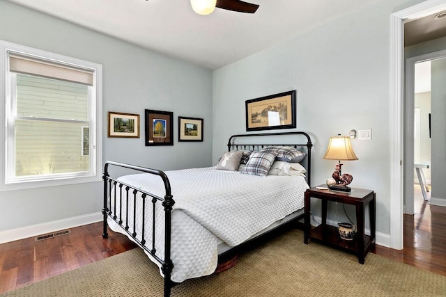 bedroom featuring visible vents, wood finished floors, baseboards, and ceiling fan