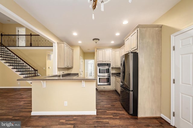 532 Tara Ct, Culpeper, VA 22701 - kitchen featuring appliances with stainless steel finishes, a peninsula, a kitchen breakfast bar, recessed lighting, and dark wood-type flooring