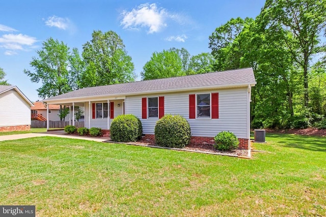 single story home featuring cooling unit and a front lawn