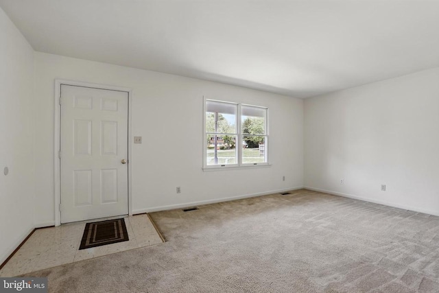 carpeted empty room with baseboards